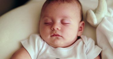 Serene infant baby face napping Adorable cute newborn baby sleeping at night