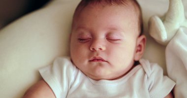 Serene infant baby face napping Adorable cute newborn baby sleeping at night
