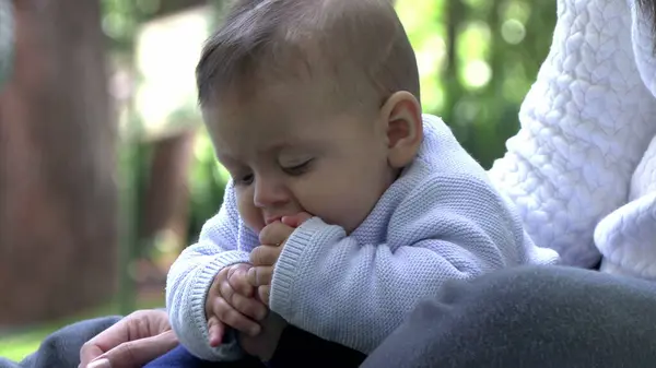 Cute baby putting foot in mouth exploring toes adorable infant outdoors