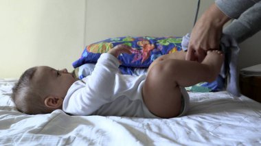 Bebeğe pantolon giydirmek.