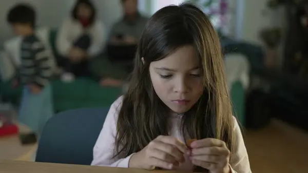 stock image Concentrated little girl assembling toy. female child putting object together engrossed in play by herself, childhood leisure activity