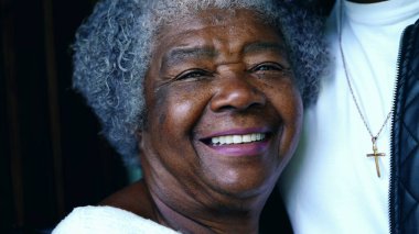 Genç Afrikalı Amerikalı torunu ve yaşlı büyükannesi, Çelişkili İki Nesil Yüzleri 'nin yakın çekimi. Aile kucaklaşması