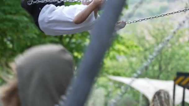 Enjoyable Family Time Mom Propels Sons Swing Playground — Stock Video