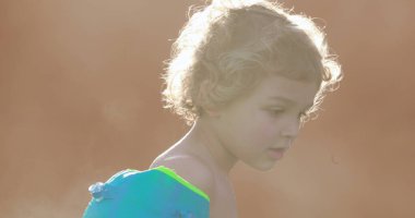 Child wearing inflatable armbands at the swimming pool