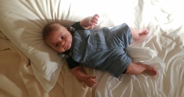 Infant baby looking at camera from above. two month old baby moving arms and legs