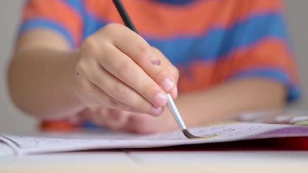 Little Boy Vigorously Paints Sketchbook Using Brush Watercolor — Stock Video