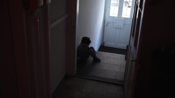 Child Seated Alone Dark Corridor Struggles Emotional Despair Covering Face — Stock Video