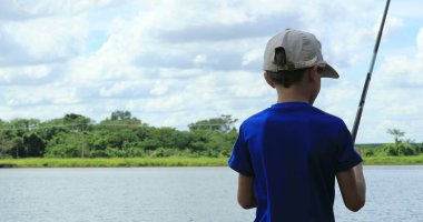 Young boy at lake fishing child outdoor leisure activity