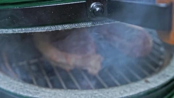 Hand Opens Portable Grill Revealing Two Delicious Steaks Sizzling Coals — Stock Video