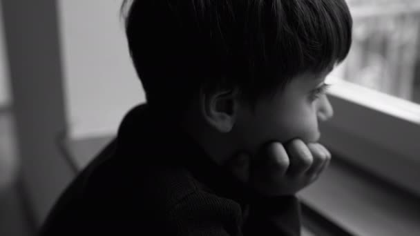 Depressed Child Stands Window Melancholic Expression Hand Chin Feeling Loneliness — Stock Video