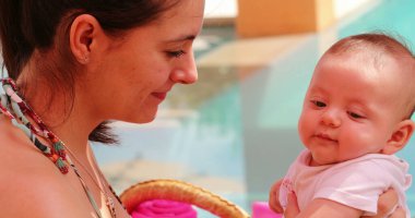 Love and affection, mother cuddling newborn baby outdoors