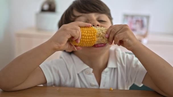 Fiatal Fiú Élvezi Forgolódást Főtt Kukoricát Mohón Rágcsálja — Stock videók