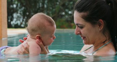 Mother and baby at the pool water