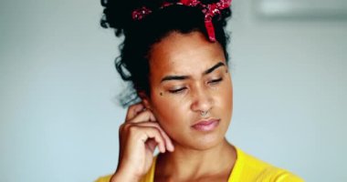 Düşünceli genç Afrikalı Amerikalı kadın, zihinsel tefekküre el sıkışarak sorunu çözmeye çalışıyor. 20 'li yaşlarda siyah Latin bir kızın yakın plan yüzü.