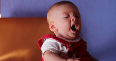 Sleepy Cute adorable baby yawning expression
