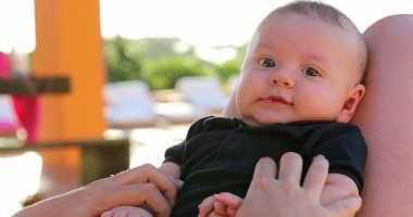 Baby boy portrait outside by the pool