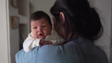 Annenin ilk haftasında kucağında yeni doğmuş bir bebeği kucağına alması annenin anneliği kucaklaması, varoluşun ilk günlerinde bebeği yanağından öpmesi.