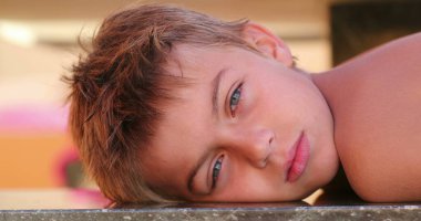 Handsome child young small boy looking to camera outdoors