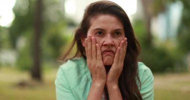 Furious young woman yelling outside feeling anxiety and stress