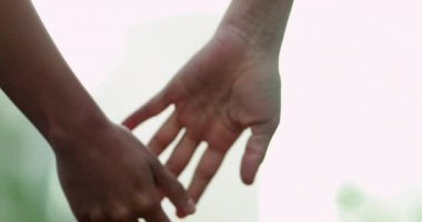 Close-up of two people joining hands together in relationship and cooperation
