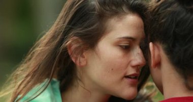 Woman sharing secret whispering information to friend ear. Girls gossiping