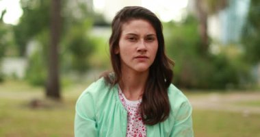 Woman shaking head in negation NO at park