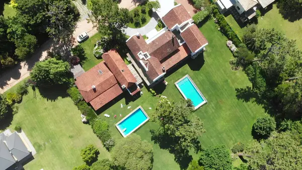 Aerial drone of suburban home wirth lawn and swimming pool