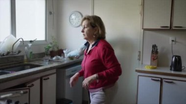 senior couple cooking together in kitchen