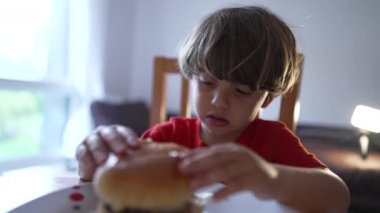 Genç çocuk Burger Patty 'nin çok sıcak ve buharlı olduğunu fark eder ve sadece çörek yemeye karar verir.