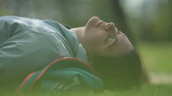 stock image Peaceful Moment in Nature - Young Woman Relaxing on the Grass