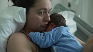 New mother in hospital bed holding newborn baby on chest, showcasing bonding and emotional connection, healthcare setting, postnatal care, nurturing love, and modern motherhood