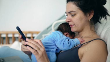 Mother in hospital bed looking at smartphone with newborn baby, multitasking between digital communication and parenting, healthcare environment, postnatal care, balancing modern responsibilities