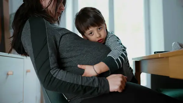 stock image Pregnant woman with her young child hugging her belly, showcasing a candid and heartfelt moment of affection and bond between mother and son