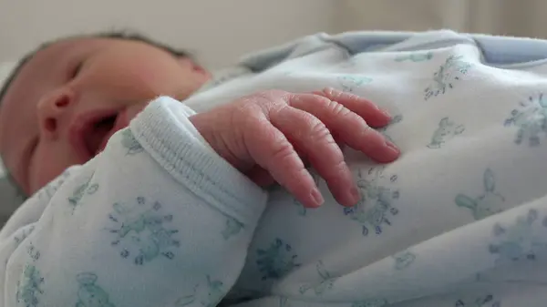 stock image Close-up newborn tiny hands during first days of life observing the world, infant in first week of life, initial stages, detail of fingers and hand