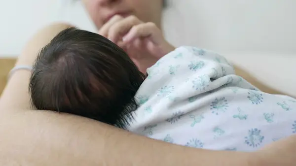 stock image Intimate close-up of a mother nursing and bonding with her newborn baby in her arms during the crucial first days of life. mom caressing infant white breastfeeding