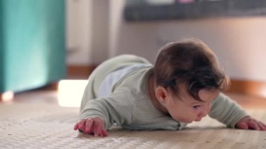 Bebek paspasın üzerinde yatıyor, yan tarafa yuvarlanıyor ve oyun sırasında sakin bir pozisyonda dinleniyor. Ev ortamında vücut hareketlerini keşfediyor.