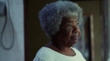 Düşünceli, son sınıf siyahi, 80 'li yaşlarda bir kadın, elleri çenesinde, sorunlarla ilgili kafa yoruyor, Afro-Amerikan gri saçlı kadının düşünceli ifadesi.