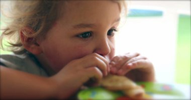 Child boy eating pancake