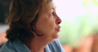 Candid older woman talking in conversation