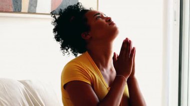 Dini bütün bir Güney Amerikalı kadın, gözleri kapalı, gökyüzüne dönüyor FAITH 'te kollarını kaldırıyor, yardım ediyor ve zor zamanlarda dua ediyor.