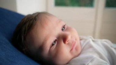 Bebek kameraya dokunmak için merceğe uzanıyor, meraklı keşif, etkileşimli an, dokuları keşfetmek, çocukluk duyusal gelişimi, oyuncu bağlılık, yakın çekim perspektifi