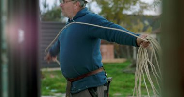 İnşaat sahasında miğferi olan işçilere kablo taşıyıp düzenlemek, el işçiliği ve dışarıda profesyonel aktiviteler sergilemek.