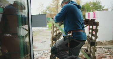 İnşaat alanında iki inşaat işçisi, takım çalışması, kask takmak, güvenlik, endüstriyel çalışma ortamı, inşaat malzemeleri, ağır işçilik, bitmemiş inşaat