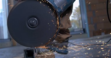 Döndürme açı öğütücü metal işleri sırasında kıvılcım yayıyor, inşaat işçisi endüstriyel projede elektrikli alet kullanıyor, süper yavaş çekim 800 fp.