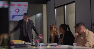 Gergin ofis toplantısı sırasında gergin bir yöneticinin el ele tutuşması, stresli performans değerlendirmesine cesaretinin kırılmasına yol açtı.