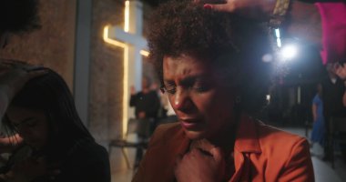 Kilise etkinliği sırasında kutsanan cemaat üyelerinin yakın çekimleri. Elleri, ruhani bir bağlantı anında başlarının üstüne yerleştirilmiş.