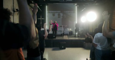 Kilisede ibadete katılan, el kaldıran, dua ve övgüye öncülük eden papaz, Protestan kilisesine ruhsal bağlılık