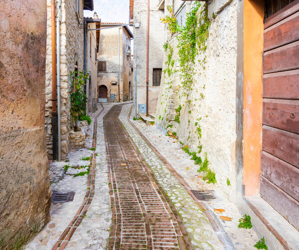 Alley with cobblestones between the ancient houses in the village of Petrella Salto in the province of Rieti. Italy.