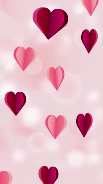 アニメーションされた縦の背景には パステルピンクの背景に赤とピンクの紙のハートが浮かんでいます バレンタインデーのコンセプトでモーショングラフィック ループアニメーションの垂直ビデオ — ストック動画