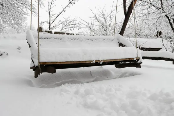 snow - covered bench with bench in winter. winter landscape